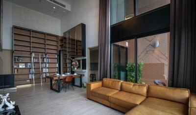 Modern living room with high ceiling and large windows