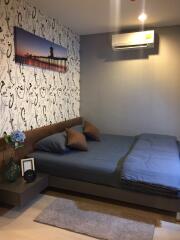 Modern bedroom with decorative wallpaper and air conditioning