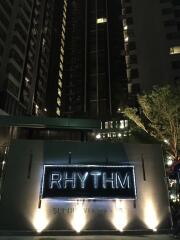 View of a modern high-rise building at night with illuminated 