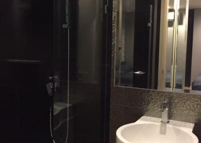 Modern bathroom with shower, sink, and mirrored cabinet