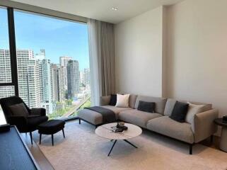 Modern living room with a large window and city view