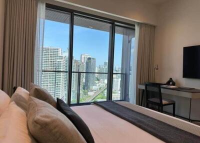 Bedroom with city view and desk area