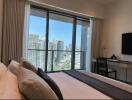 Bedroom with city view and desk area