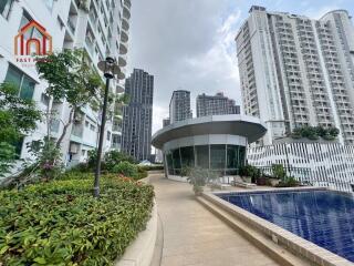 Modern residential building with landscaped walkway and pool