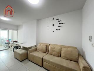 Living room with beige sofa and wall clock