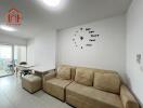 Living room with beige sofa and wall clock