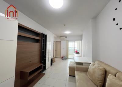 Living room with built-in shelving and beige sofa