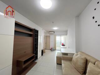 Living room with built-in shelving and beige sofa