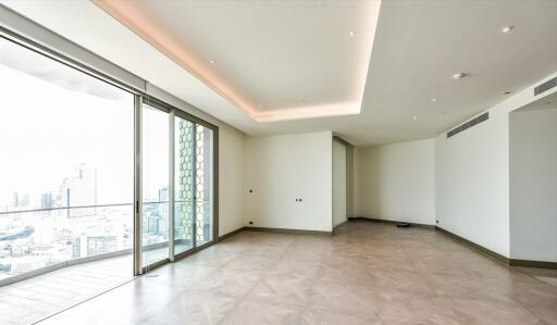 Spacious living room with large windows and city view