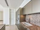 Modern kitchen with marble countertops and sleek cabinetry