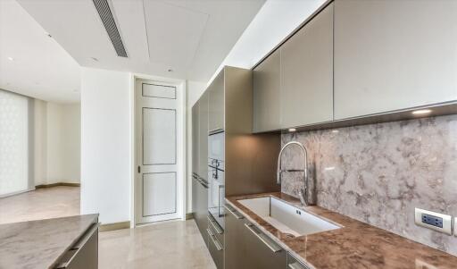 Modern kitchen with marble countertops and sleek cabinetry