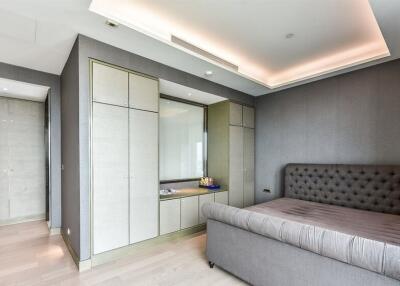 Spacious modern bedroom with built-in closet and upholstered bed