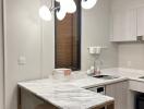 Modern kitchen with pendant lighting and marble countertop