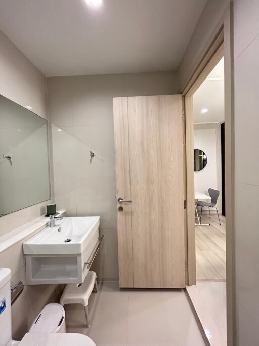 Modern bathroom with sink, mirror, and toilet