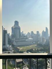 View of cityscape from balcony with modern high-rise buildings