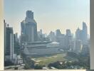 View of cityscape from balcony with modern high-rise buildings