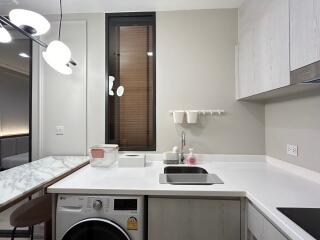 Modern kitchen with built-in appliances and marble countertop