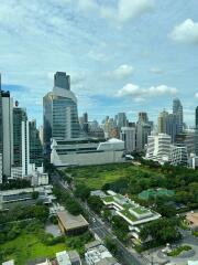 Aerial view of city skyline with modern skyscrapers and green spaces