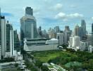 Aerial view of city skyline with modern skyscrapers and green spaces