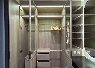 Spacious walk-in closet with open shelves and hanging space