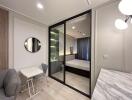 Modern bedroom with glass partition, seating and study area