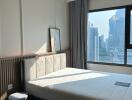 Modern bedroom with large window and city view