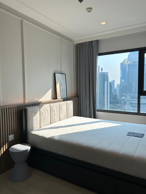 Modern bedroom with large window and city view