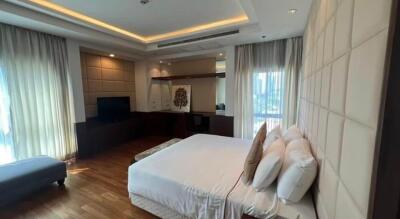 Spacious bedroom with double bed, hardwood floors, large windows, and modern lighting