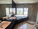 Modern bathroom with city view, featuring dual sinks, bathtub, and glass shower