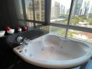 Bathroom with large bathtub and city view