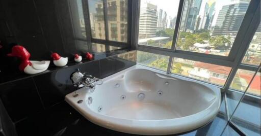 Bathroom with large bathtub and city view