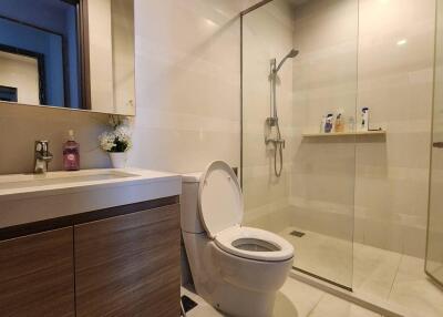 Modern bathroom with vanity, toilet, and glass shower