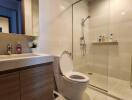 Modern bathroom with vanity, toilet, and glass shower