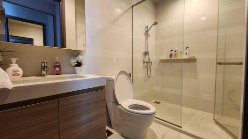 Modern bathroom with vanity, toilet, and glass shower