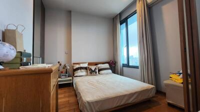 Bedroom with a large window and minimalist decor