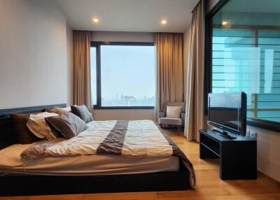 Modern bedroom with large window and city view