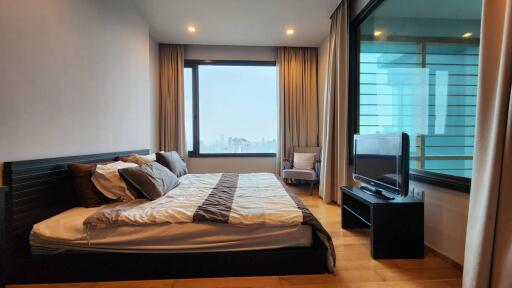 Modern bedroom with large window and city view