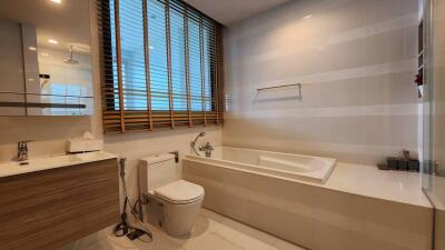 Modern bathroom with bathtub and wooden accents