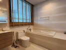 Modern bathroom with bathtub and wooden accents