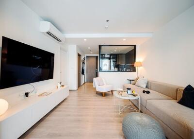 Modern and cozy living room with neutral tones and contemporary furnishings.