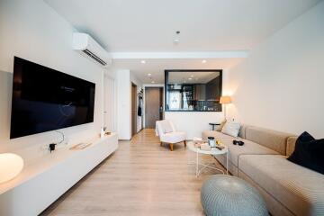 Modern and cozy living room with neutral tones and contemporary furnishings.