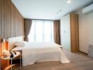 Modern bedroom with wood paneling and large window