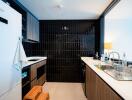 Modern kitchen with black tiled backsplash and wooden cabinets