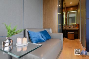 Modern living room with a grey sofa and glass side table