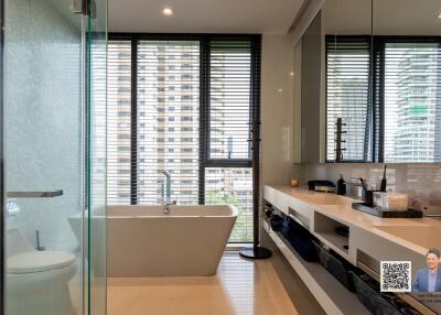 Modern bathroom with large windows and city view
