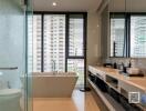 Modern bathroom with large windows and city view