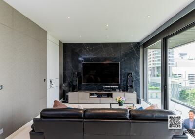 Modern living room with large TV and sleek furnishings