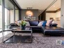 Modern living room with black leather sofa and glass coffee table