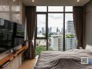 Modern bedroom with large windows and city view