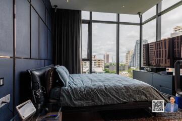 Modern bedroom with large windows and city view